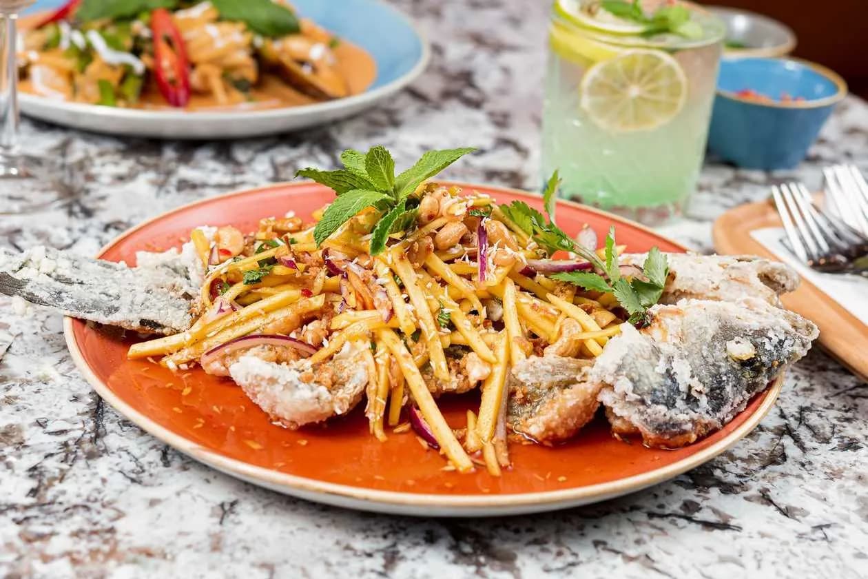 Fried Seabass with Mango, Lemongrass, Coriander, Red Onions, Peanuts, Cashew Nuts and Coconut Shreds