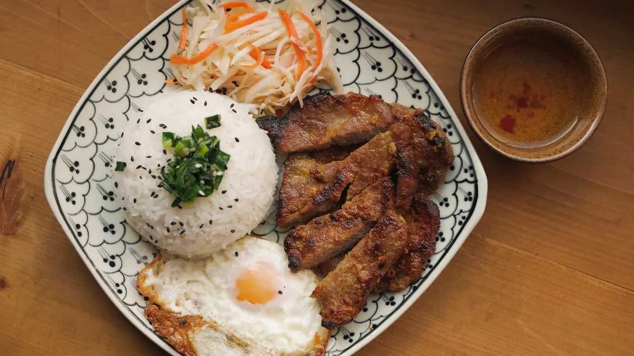 Pork chop marinated and grilled, fried egg