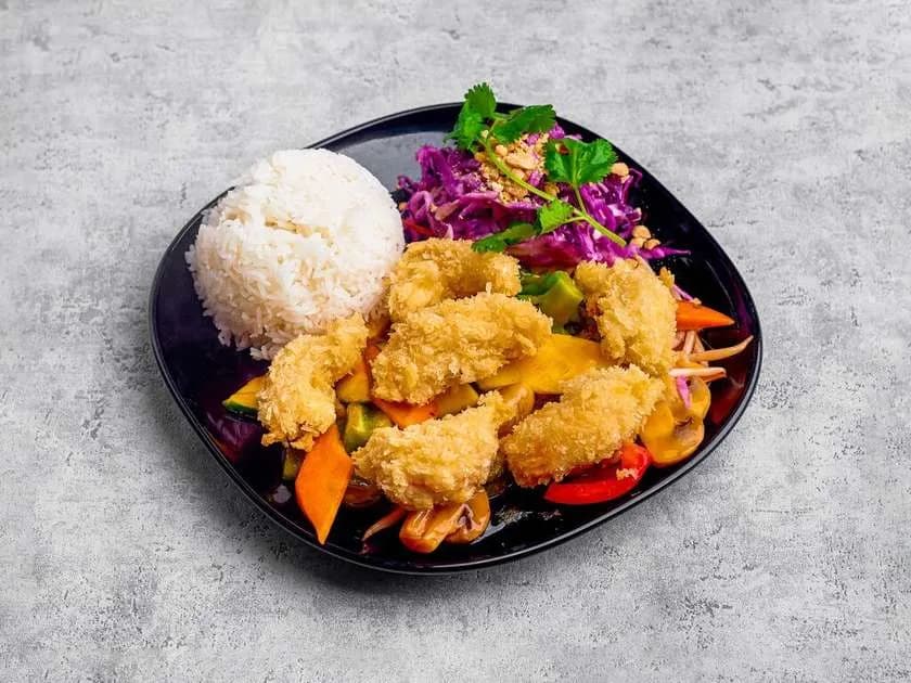 Crispy vegan shrimps in sweet and sour sauce with rice and salad