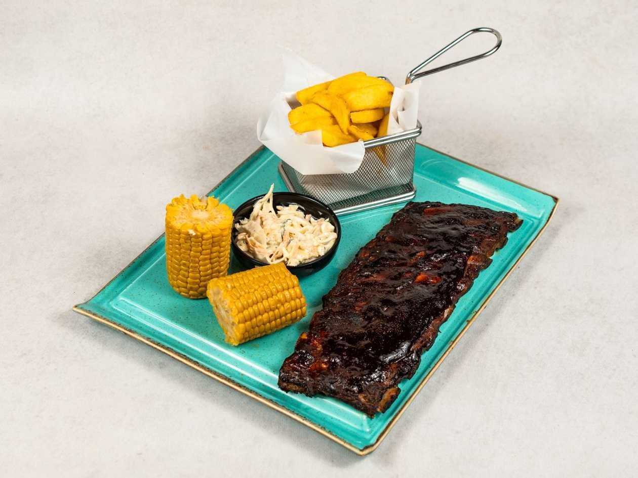 Pork ribs, baked potatoes, pickled cucumber salad, bbq sauce