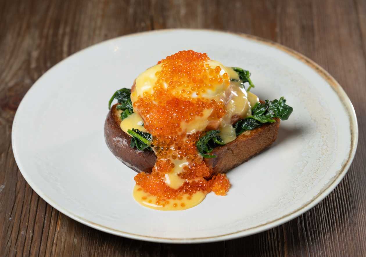 Eggs Benedict with Hollandaise Sauce, Spinach, Salmon, and Caviar