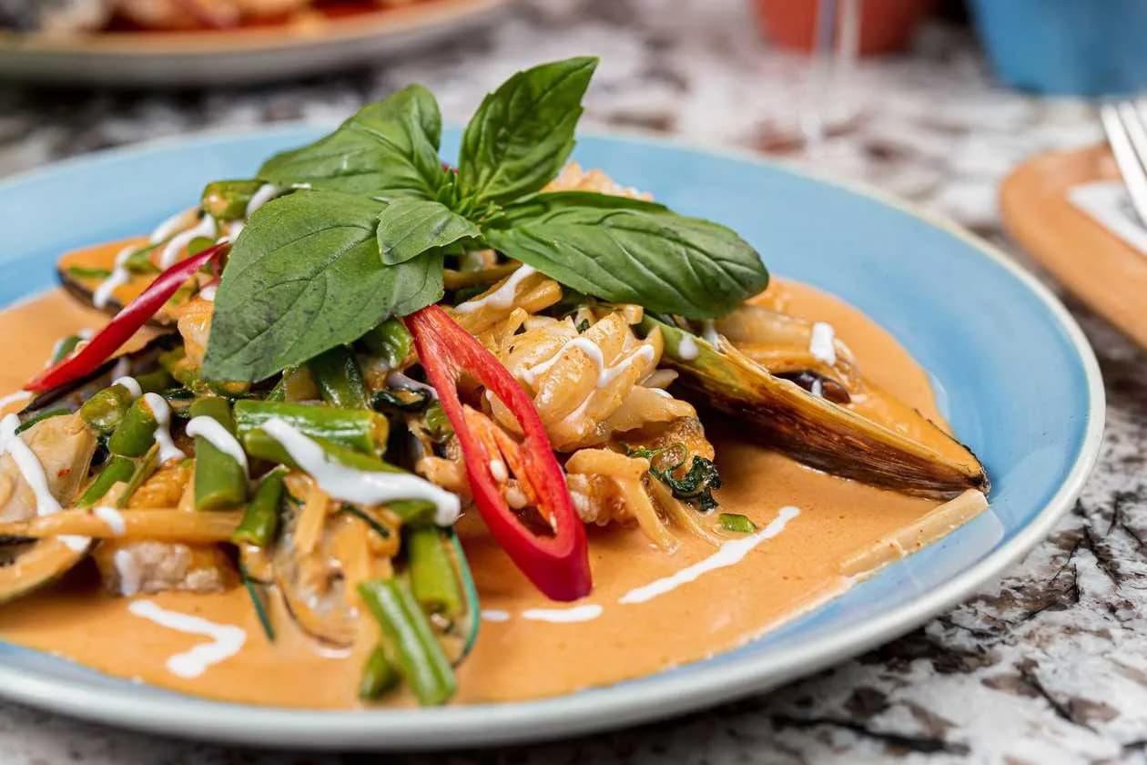 Stir Fried Shrimps, Calamari, Mussels and Cod with Red Curry Paste, Coconut Milk, Green Beans, Bamboo Shoots and Kaffir Lime Leaves