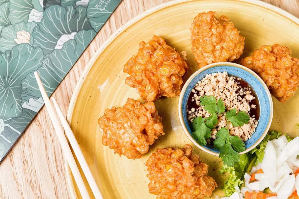 Corn Fritters with Red Curry Paste and Kaffir Lime Leaves Served with Sweet Chili Sauce