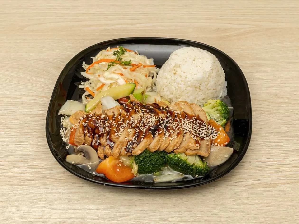 Vegan roast of seitan in teriyaki sauce with rice and salad