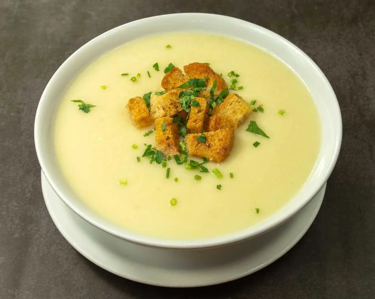 Vegetable cream soup served with puff peas