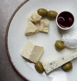 Talerz serów z konfiturą i oliwkami